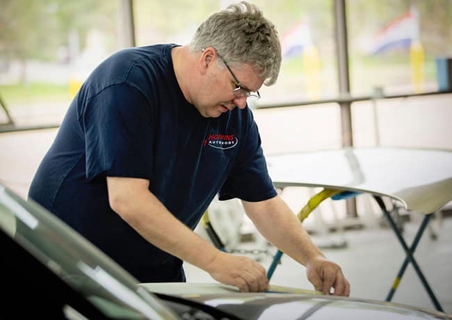 certified collision repair technician measuring body panel at CSN Hopkins
